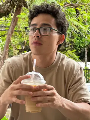Con un vaso de café frío, polera beige UEBOS